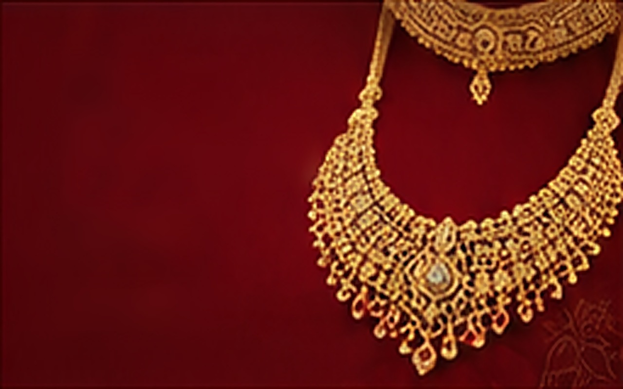 Gold bridal necklace on maroon velvet